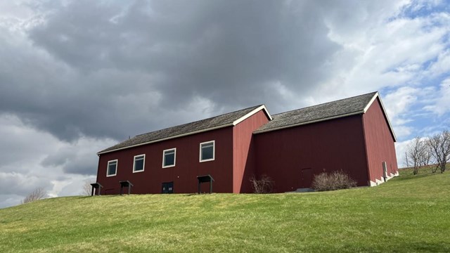 An 1880s farmhouse with the dam abutments in the snow.